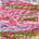 Colorful handspun yarn with pink, green, and purple hues on a white background.