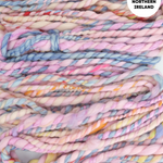 Handspun yarn with pastel colors and text 'Handspun in Northern Ireland' on a white background