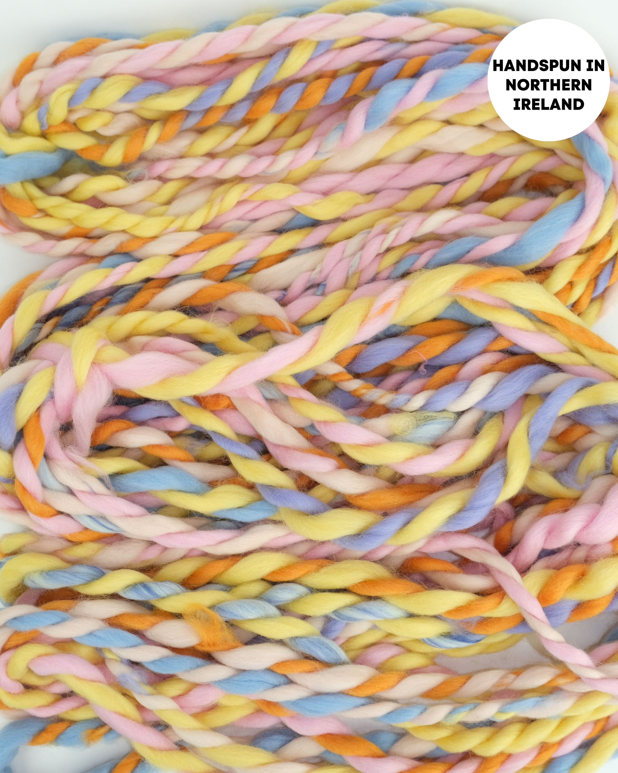 Pastel-colored yarn braid with 'Handspun in Northern Ireland