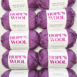Multiple skeins of Hope's Wool chunky yarn in Açaí Purple – 100% Merino wool, grown in Uruguay and manufactured in the UK, ideal for hand knitting and DIY projects.