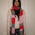 A woman with a colourful scarf around her neck.