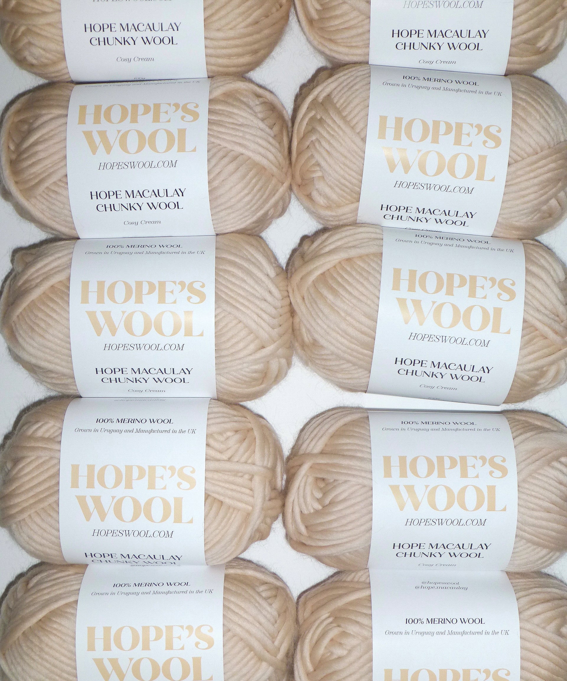An arrangement of creamy-colored Merino wool balls neatly lined up in a row.