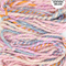 Handspun yarn with pastel colors on a white background, labeled 'Handspun in Northern Ireland'.