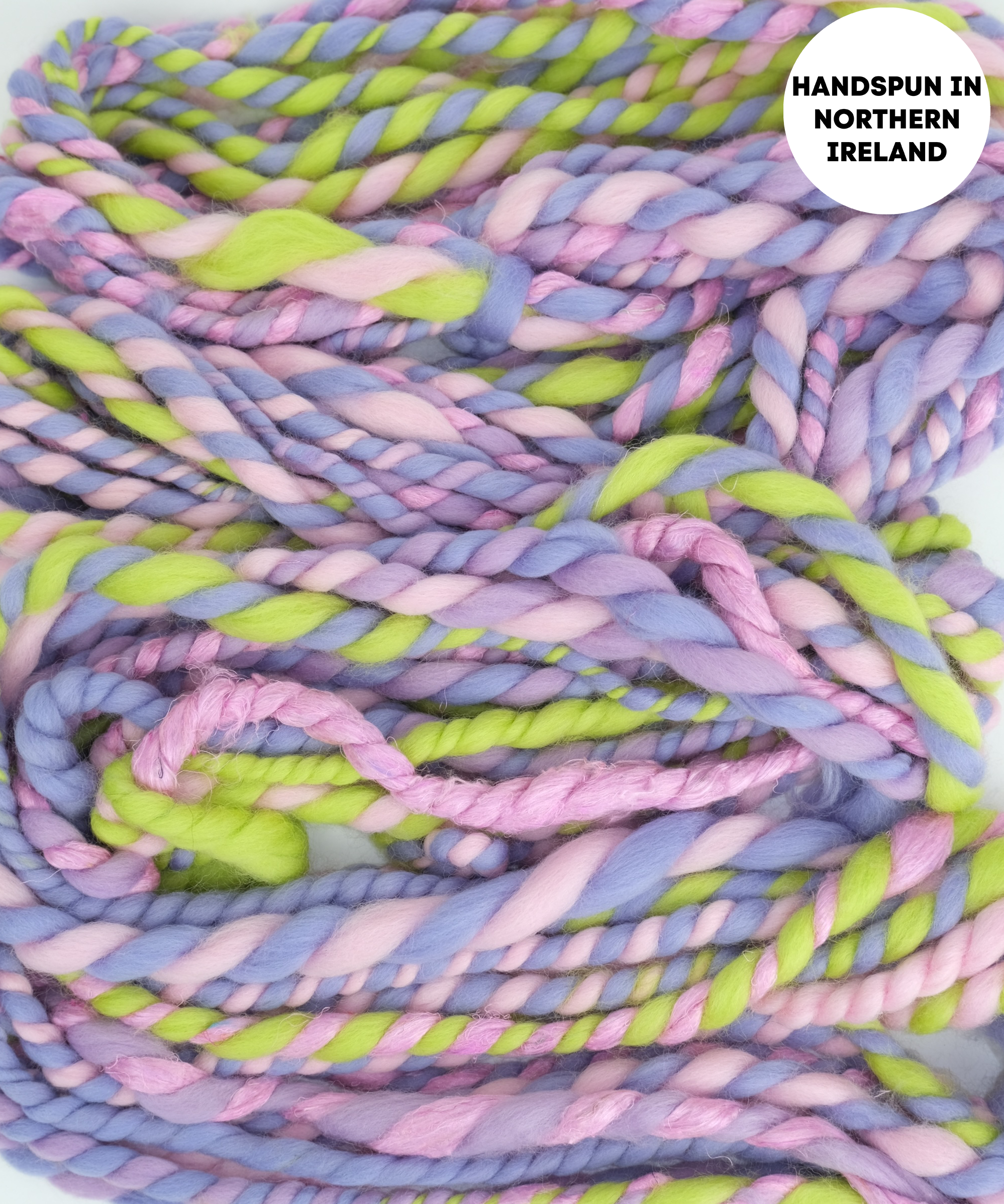 Handspun yarn in pastel colors with 'Hands spun in Northern Ireland' text.