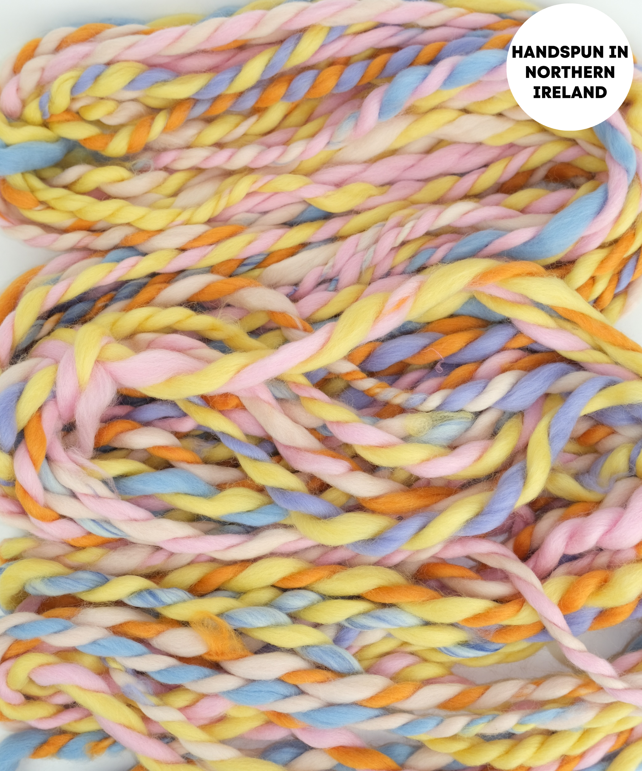 Pastel-colored yarn braid with 'Handspun in Northern Ireland 