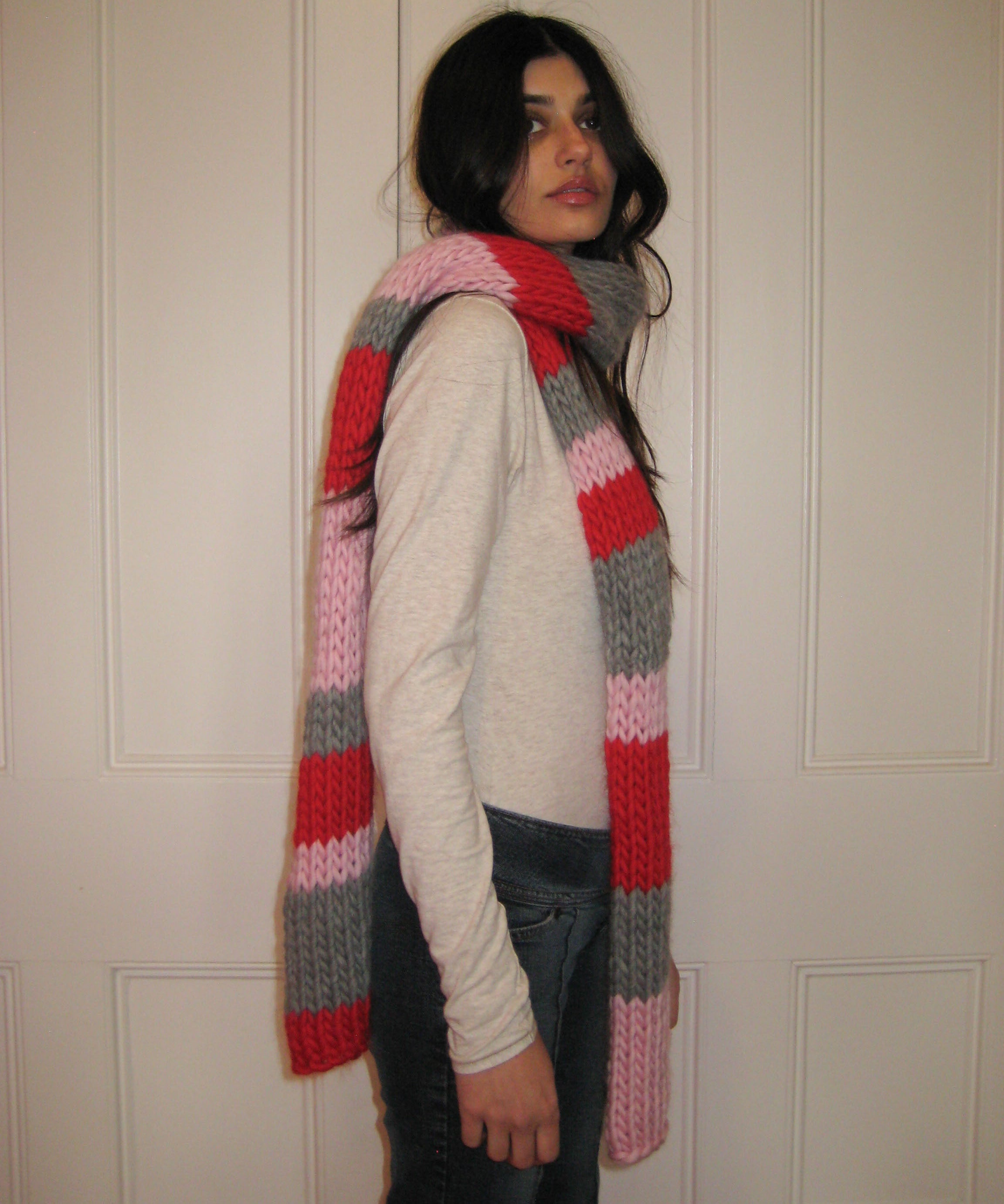 A woman with a colourful scarf around her neck.