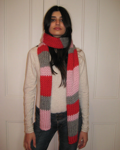 A woman with a colourful scarf around her neck.