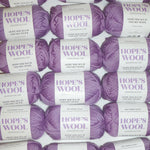 Purple color merino wool balls lined up in rows