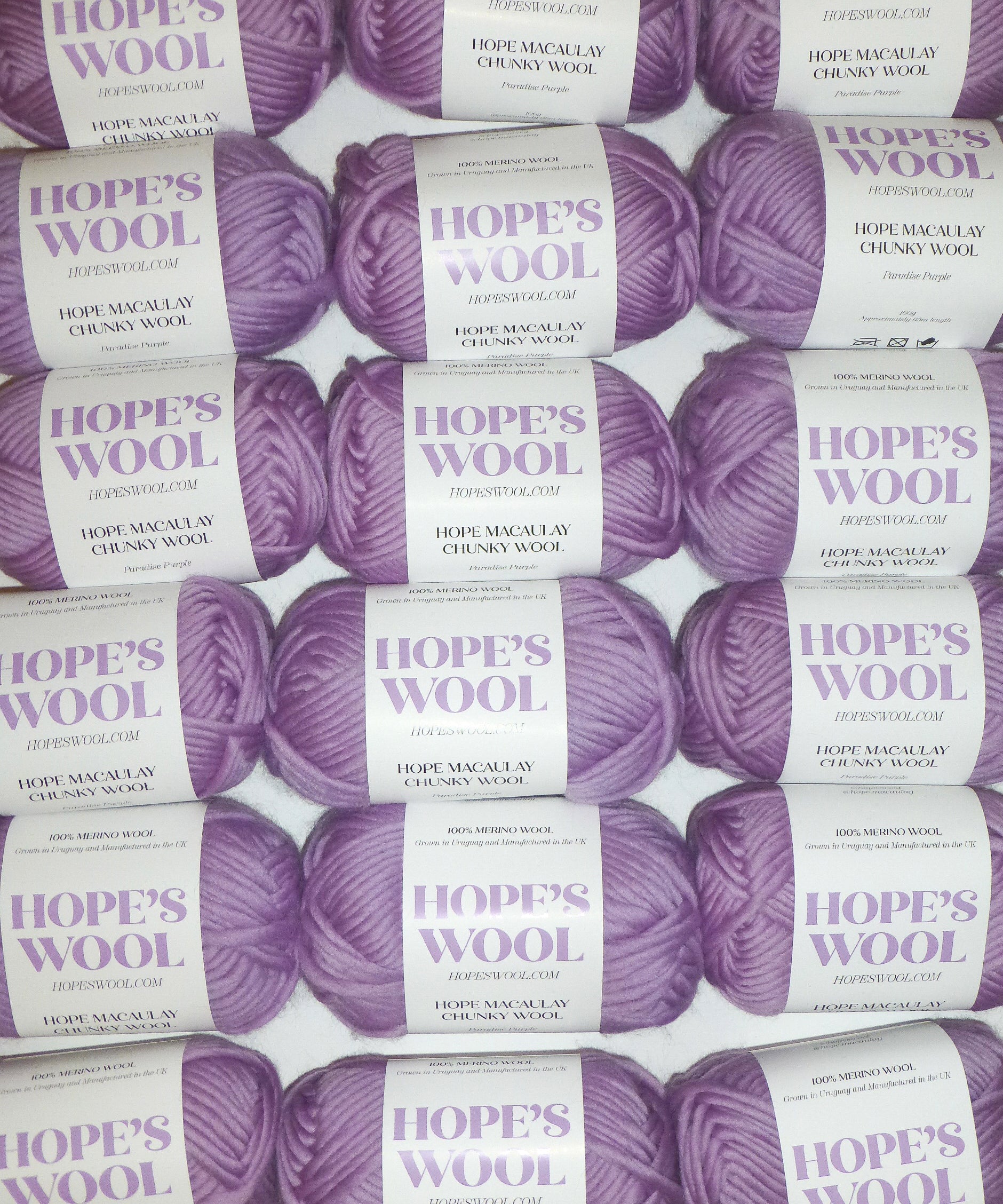 Purple color merino wool balls lined up in rows