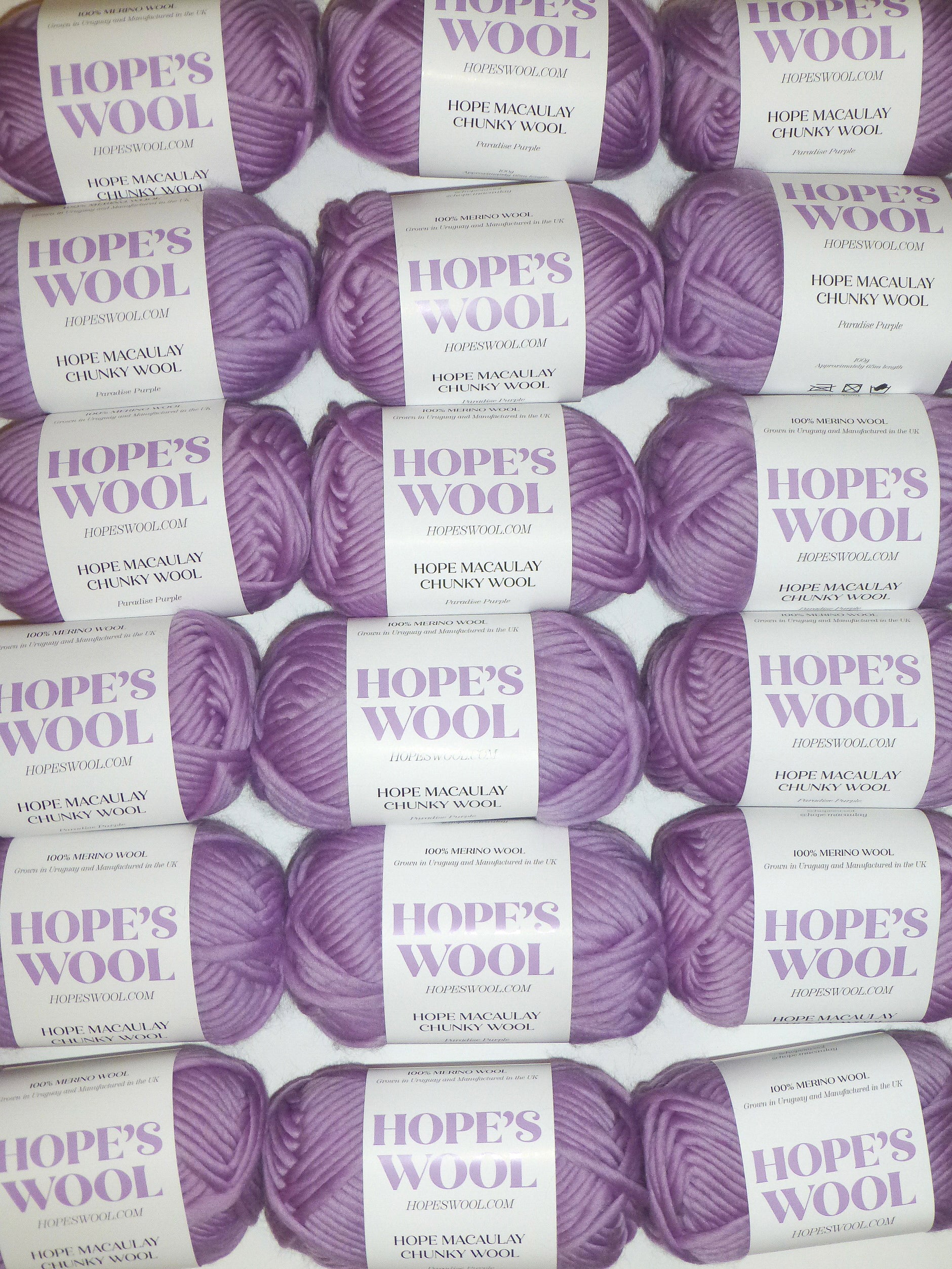 Purple color merino wool balls lined up in rows