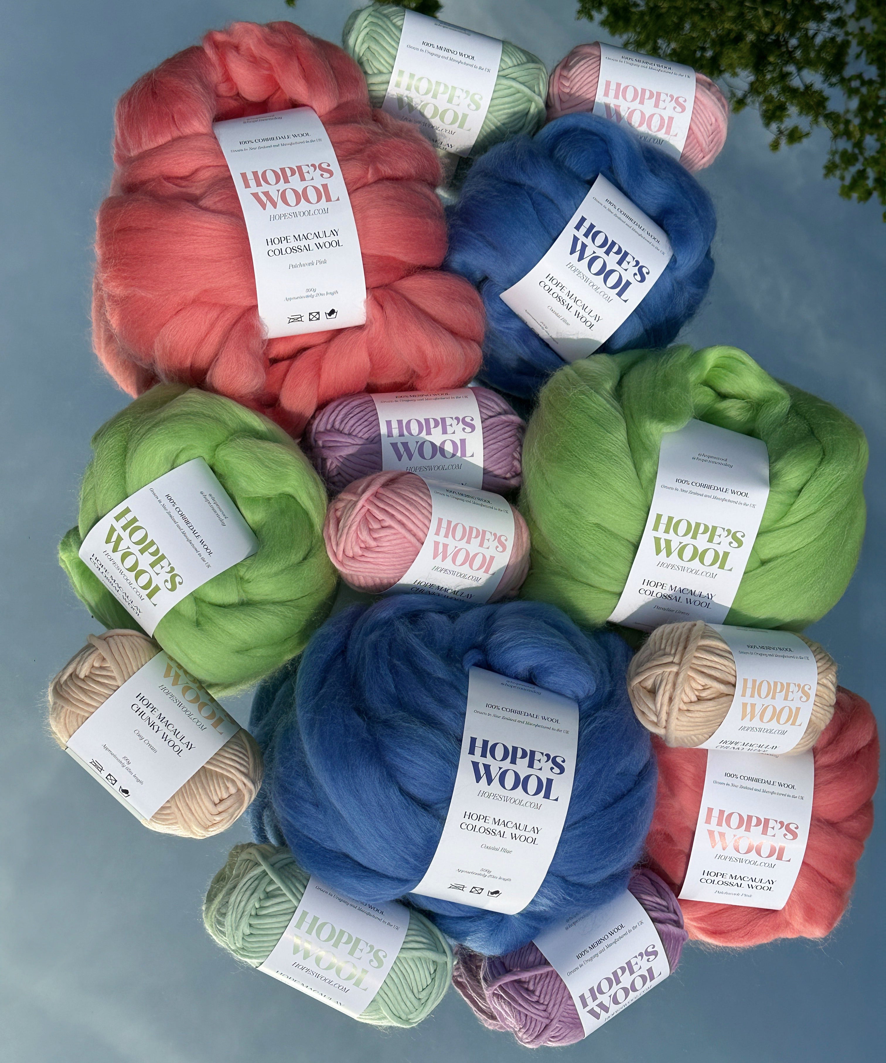 Balls of Corriedale wool in Pink, Blue and Green sitting on a mirror